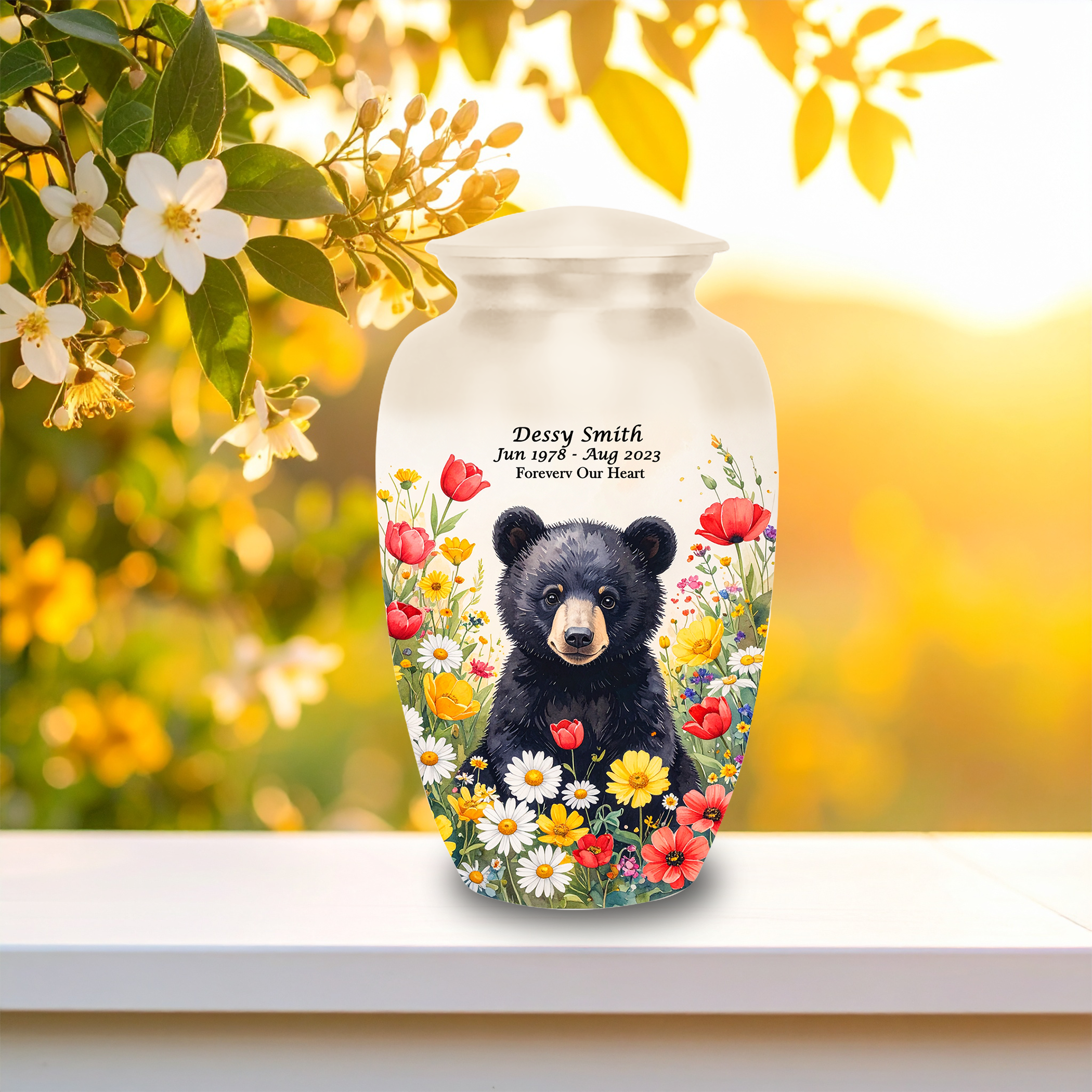 Decorative cremation urn featuring bear cub in wildflowers